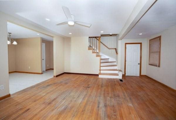 30 Royal St, Randolph, MA 02368 - unfurnished room with hardwood / wood-style floors, stairway, baseboards, ceiling fan, and recessed lighting