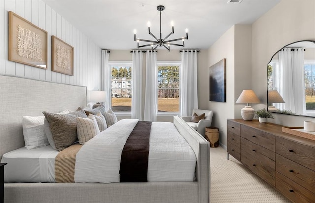 bedroom with visible vents, an inviting chandelier, and light colored carpet