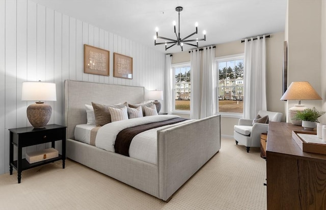 bedroom featuring light carpet and a notable chandelier
