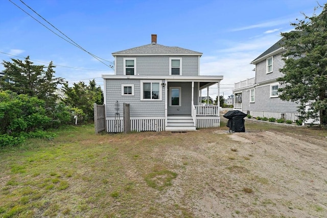 18 Marshfield Ave, Scituate, MA 02066 - back of house with a chimney, a porch, and roof with shingles