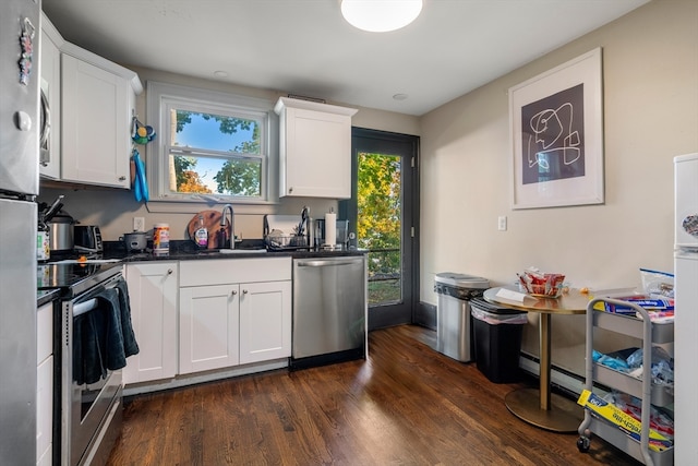 kitchen with sink, appliances with stainless steel finishes, white cabinets, and dark hardwood / wood-style flooring