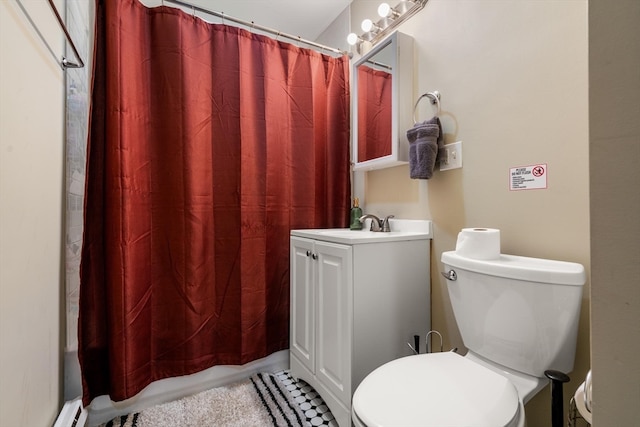 bathroom with vanity, a shower with shower curtain, and toilet