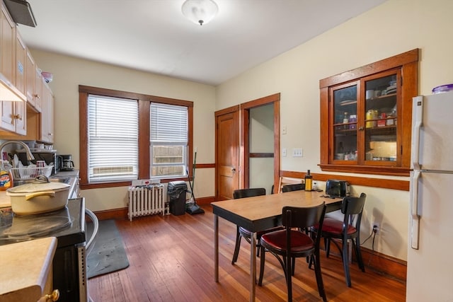 dining room featuring radiator heating unit and dark hardwood / wood-style floors