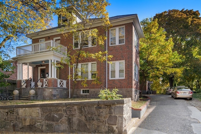 view of front of house featuring a balcony