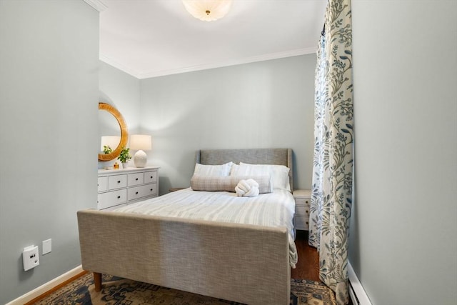 bedroom with dark wood-style flooring, crown molding, and baseboards