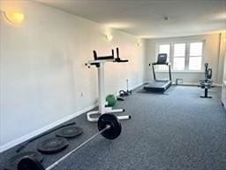 workout room featuring baseboards