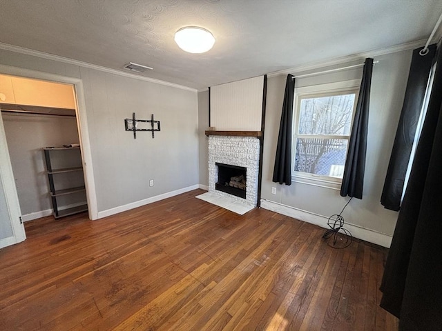 unfurnished living room with crown molding, a textured ceiling, and hardwood / wood-style flooring