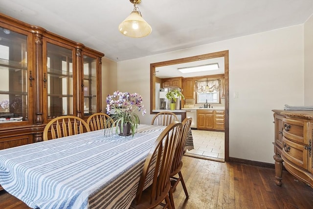 dining area featuring dark wood-type flooring and sink