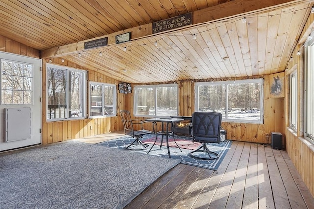 sunroom with plenty of natural light, vaulted ceiling, and wooden ceiling