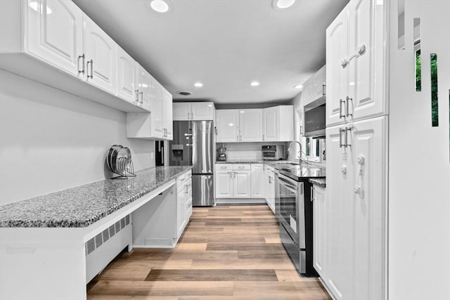 15 Leonard Rd, Sharon, MA 02067 - kitchen with stainless steel appliances, light wood-style flooring, recessed lighting, white cabinets, and stone countertops