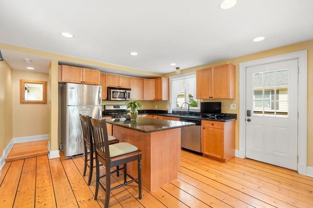 35 Commercial St Unit A, Marblehead, MA 01945 - kitchen featuring stainless steel appliances, a center island, a breakfast bar area, light wood-type flooring, and recessed lighting