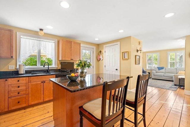 35 Commercial St Unit A, Marblehead, MA 01945 - kitchen featuring a kitchen breakfast bar, a kitchen island, light wood finished floors, recessed lighting, and open floor plan