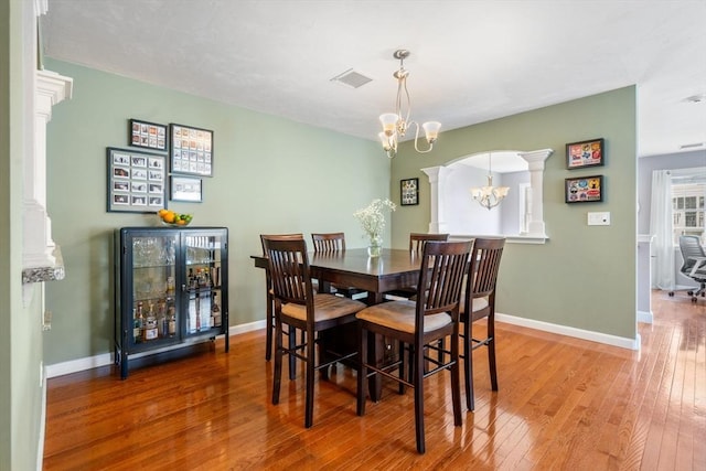 622 Hampton Way Unit 622, Abington, MA 02351 - dining room with decorative columns, wood-type flooring, a chandelier, baseboards, and arched walkways