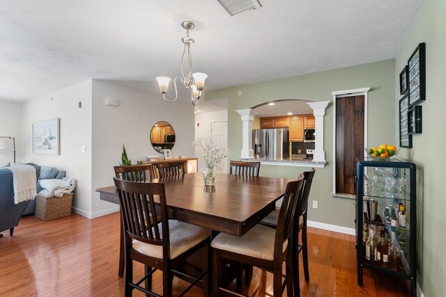 622 Hampton Way Unit 622, Abington, MA 02351 - dining area with decorative columns, arched walkways, wood finished floors, baseboards, and a chandelier
