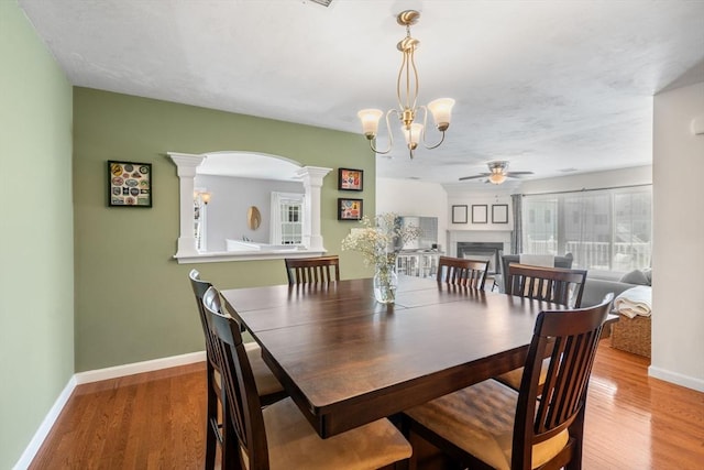 622 Hampton Way Unit 622, Abington, MA 02351 - dining room with decorative columns, ceiling fan, baseboards, a fireplace, and light wood-style floors