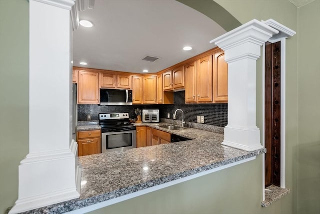 622 Hampton Way Unit 622, Abington, MA 02351 - kitchen with appliances with stainless steel finishes, a sink, ornate columns, dark stone countertops, and backsplash