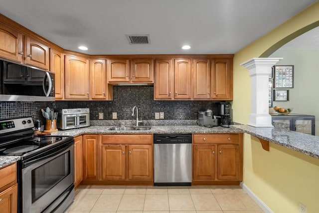 622 Hampton Way Unit 622, Abington, MA 02351 - kitchen with appliances with stainless steel finishes, a sink, light stone counters, backsplash, and ornate columns