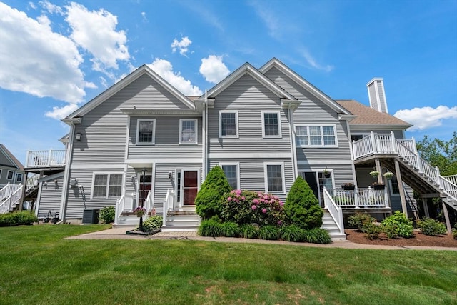 622 Hampton Way Unit 622, Abington, MA 02351 - townhome / multi-family property featuring stairs, a chimney, a front lawn, and central air condition unit