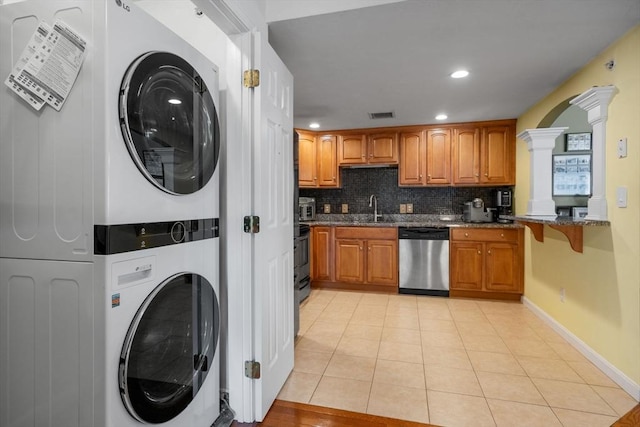622 Hampton Way Unit 622, Abington, MA 02351 - washroom featuring stacked washer / dryer, ornate columns, light tile patterned floors, recessed lighting, and baseboards