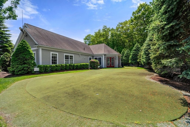622 Hampton Way Unit 622, Abington, MA 02351 - view of front facade with french doors, a front yard, a shingled roof, and a putting area