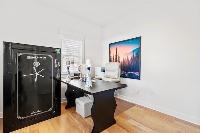 office space featuring baseboards and wood finished floors