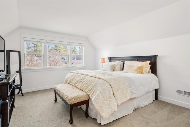 bedroom with baseboards, vaulted ceiling, carpet flooring, and visible vents