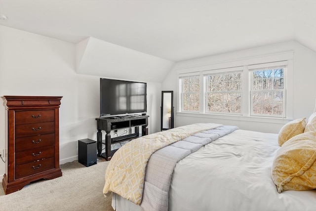 bedroom featuring light colored carpet, baseboards, and vaulted ceiling