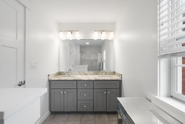 full bath with a sink, tile patterned floors, double vanity, and a shower with shower curtain