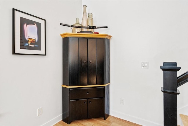 interior details with baseboards and wood finished floors