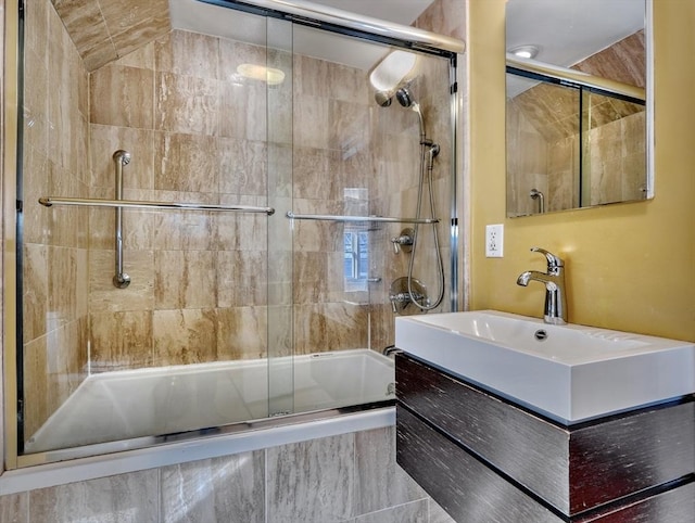 bathroom featuring vanity and enclosed tub / shower combo