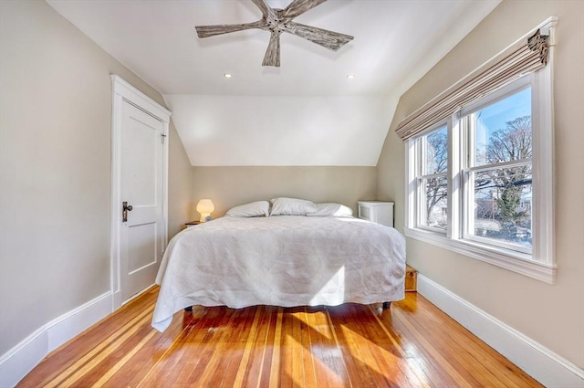 bedroom with lofted ceiling, light hardwood / wood-style floors, and ceiling fan