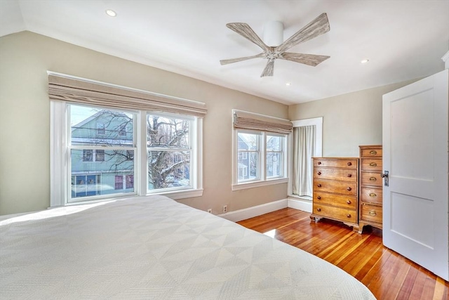 bedroom featuring lofted ceiling, ceiling fan, and light wood-type flooring