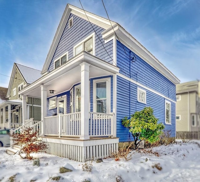 view of snowy exterior with a porch