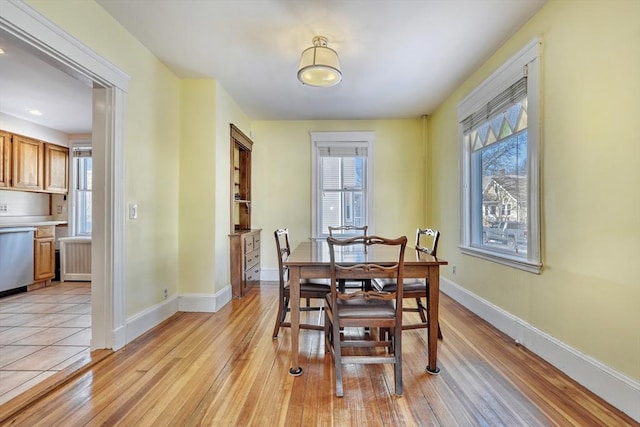 dining space with light hardwood / wood-style flooring and plenty of natural light