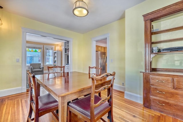 dining area with light hardwood / wood-style flooring