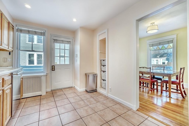 doorway to outside with light tile patterned floors