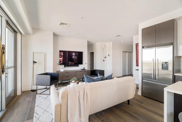 living area featuring dark wood-style floors and baseboards