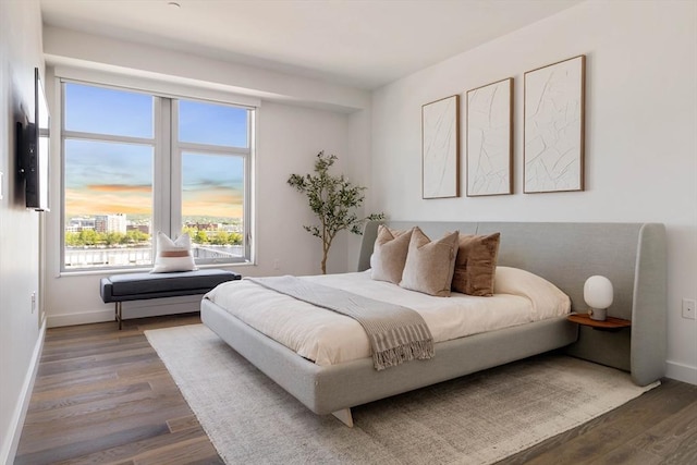 bedroom featuring wood finished floors and baseboards