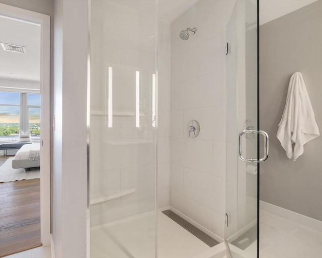 full bathroom with a shower stall, baseboards, and tile patterned flooring