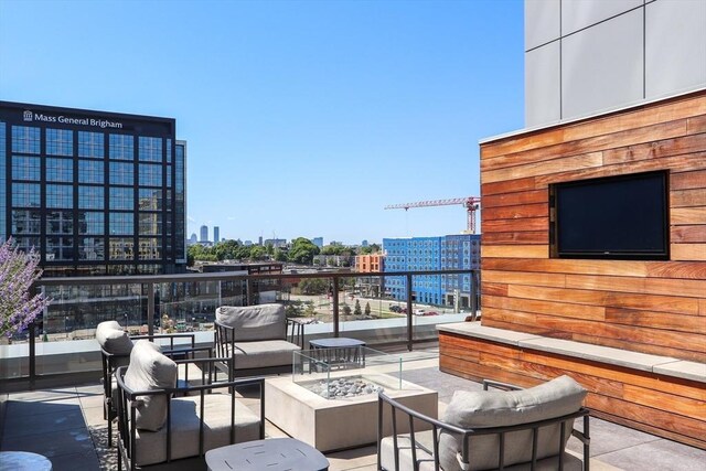 view of patio featuring an outdoor living space with a fire pit