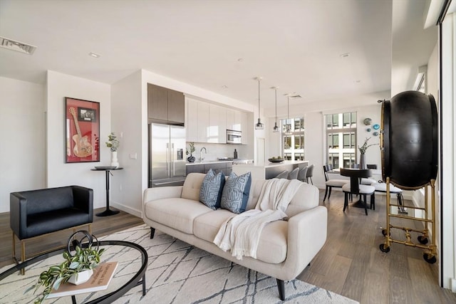 living area with light wood-type flooring and baseboards