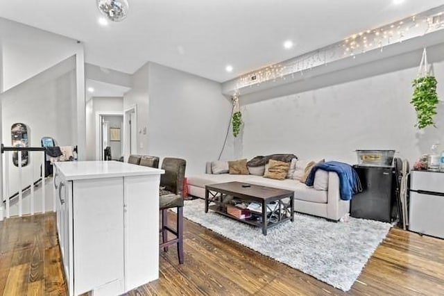 living area featuring dark wood-style flooring and recessed lighting