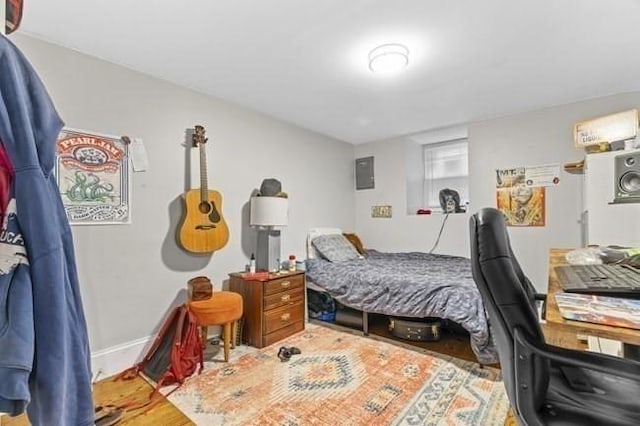bedroom featuring wood finished floors and baseboards
