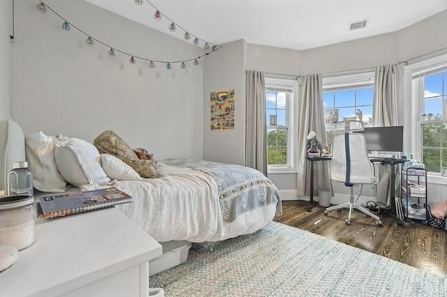 bedroom featuring wood finished floors and baseboards