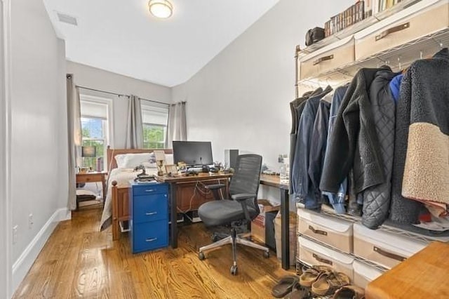 office with wood finished floors, lofted ceiling, and baseboards