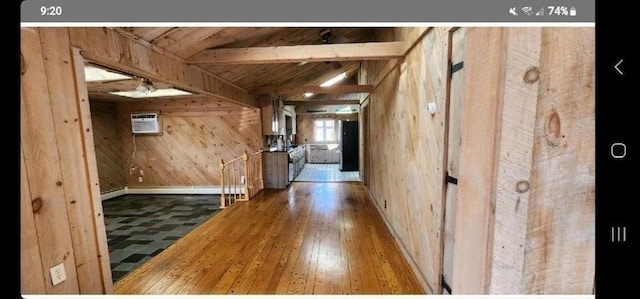 corridor with a wall unit AC, wooden walls, wood-type flooring, wooden ceiling, and beamed ceiling