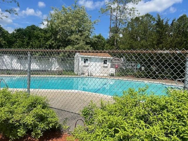 2 Markham Unit C, Ayer, MA 01432 - view of swimming pool with fence and view of wooded area