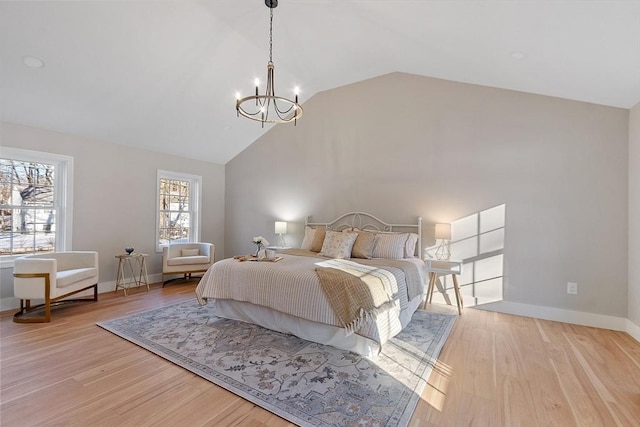 bedroom with vaulted ceiling, light wood finished floors, an inviting chandelier, and baseboards