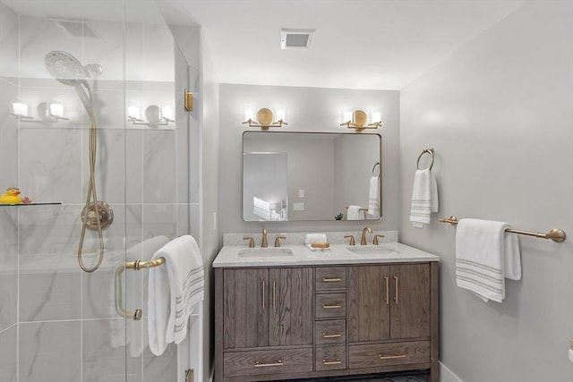 bathroom featuring double vanity, a sink, visible vents, and a shower stall