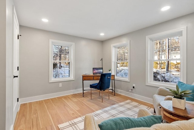 office space featuring baseboards, light wood-type flooring, and recessed lighting